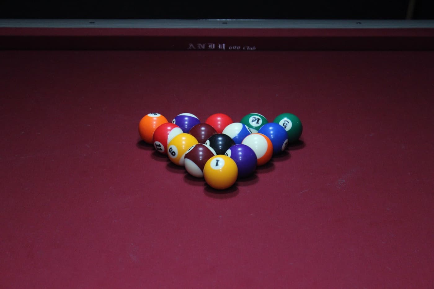 Racked balls on red felt, seen close