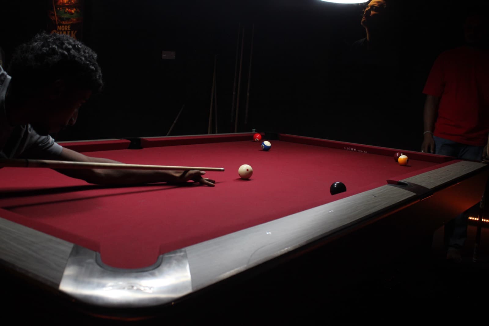 A corner pocket where felt meets polished trim